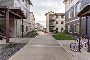 Woodburn apartment for rent - A bicycle is parked on a sidewalk in a residential area at Woodburn Place Apartment Homes, Oregon, 97071
