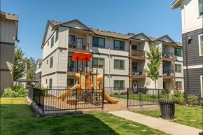 Forest Grove apartment for rent - A playground with a slide is in front of a building at Forestplace Apartment Homes, Oregon