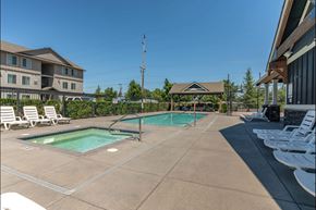 Forest Grove apartment for rent - A large outdoor swimming pool with lounge chairs and a gazebo at Forestplace Apartment Homes, Forest Grove, Oregon