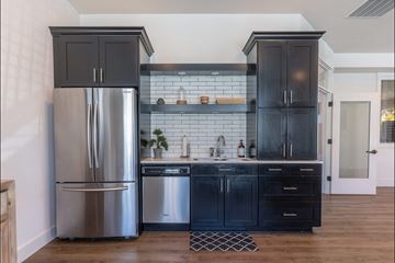 Forest Grove apartment for rent - A kitchen with a stainless steel refrigerator and black cabinets.