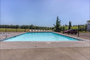 Independence apartment for rent - A large outdoor swimming pool surrounded by a fence at Riverplace Apartment Homes, Independence