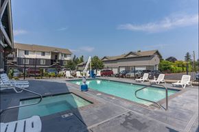 Sandy apartment for rent - A swimming pool with a slide and lounge chairs at Sandyplace Apartment Homes, Oregon