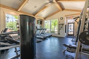 Silverton apartment for rent - A gym with a row of treadmills and a weight rack at Silverplace Apartment Homes, Silverton, OR