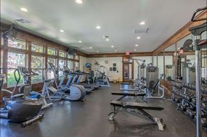 Molalla apartment for rent - A spacious gym with a variety of equipment including treadmills, weights, and exercise machines at Stoneplace Apartment Homes, Molalla, 97038