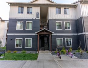 Woodburn apartment for rent - A two-story house with a front porch and a bicycle parked in front.