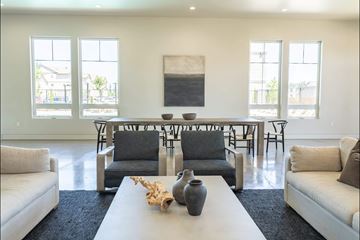 Salem apartment for rent - A living room with a white couch, a white coffee table, and a large painting on the wall.