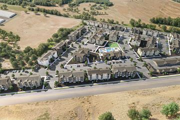Hermiston apartment for rent - A bird's eye view of a residential area with houses and a swimming pool.