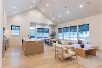 Hermiston apartment for rent - A spacious kitchen with a dining area and a living room with a couch and a coffee table.