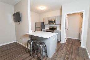 West Lafayette apartment for rent - A kitchen with a white counter and a microwave above it.