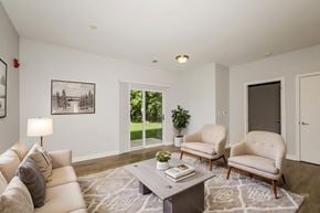 West Lafayette apartment for rent - A living room with a white couch, a coffee table, and a potted plant.