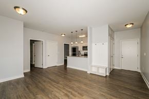 West Lafayette apartment for rent - A spacious room with wooden floors and white walls.