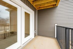 Lafayette apartment for rent - A patio with a sliding glass door and a black railing.