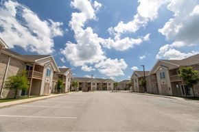 West Lafayette apartment for rent - A row of houses with a parking lot in front.