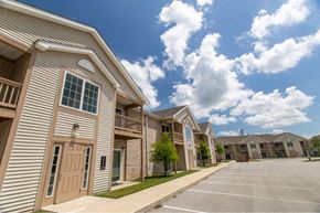 West Lafayette apartment for rent - A row of apartment buildings with a parking lot in front.