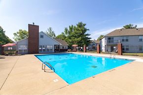 Lafayette apartment for rent - A small pool in a backyard with a house in the background.