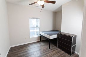 West Lafayette apartment for rent - A bedroom with a bed, dresser, and window.