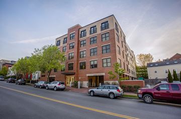 Portland apartment for rent - A red brick building with a yellow line in front of it.