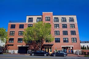 Portland apartment for rent - A red brick building with a tree in front of it.