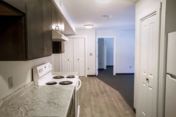 Auburn apartment for rent - A kitchen with a stove top oven and a refrigerator.