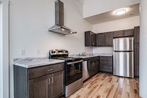 Lewiston apartment for rent - A kitchen with wooden floors and stainless steel appliances.