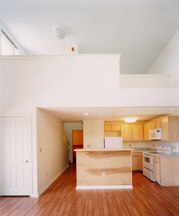 Portland apartment for rent - A kitchen with wooden floors and white walls.