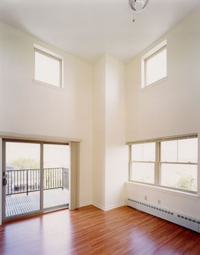 Portland apartment for rent - A room with a sliding glass door and hardwood floors.