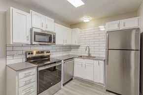 Hixson apartment for rent - A kitchen with white cabinets and stainless steel appliances.