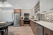 Windsor apartment for rent - A modern kitchen with a stainless steel refrigerator and a black and white tiled backsplash