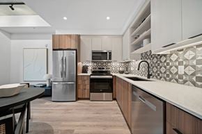 Windsor apartment for rent - A modern kitchen with a stainless steel refrigerator and a black and white tiled backsplash