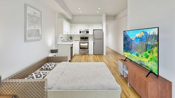 Listowel apartment for rent - A modern living room with a television on a wooden stand.