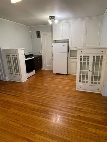 St. Paul apartment for rent - A kitchen with white cabinets and a white fridge.