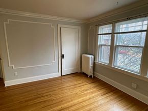 St. Paul apartment for rent - A room with a door, a window, and a radiator.