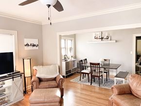 Minneapolis apartment for rent - A living room with a brown chair and a brown ottoman.