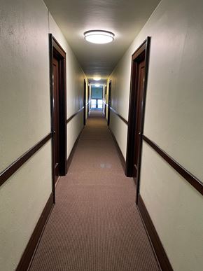 Saint Paul apartment for rent - A long hallway with brown carpeting and white walls.