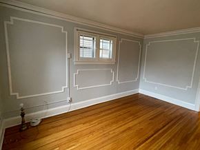 St. Paul apartment for rent - A room with wooden floors and white walls.