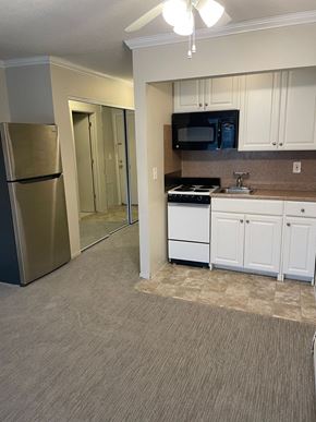St. Paul apartment for rent - A kitchen with white cabinets and a stainless steel refrigerator.