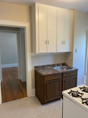 St. Paul apartment for rent - A kitchen with a white stove and wooden cabinets.