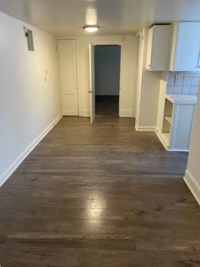 Saint Paul apartment for rent - A long hallway with wood floors and white walls.