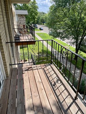 St. Paul apartment for rent - A balcony with a table and chairs overlooking a street.