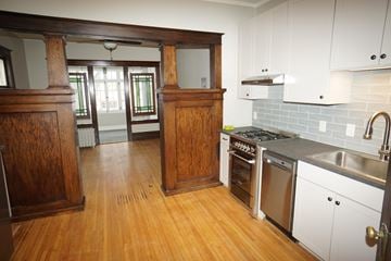 St. Paul apartment for rent - A kitchen with wooden cabinets and a white backsplash.