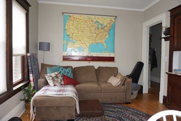 St. Paul apartment for rent - A living room with a couch and a map of the United States on the wall.