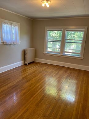 St. Paul apartment for rent - A room with a wooden floor and a window.