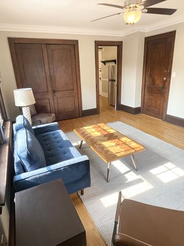 St. Paul apartment for rent - A living room with a blue couch and a wooden coffee table.