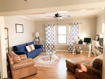Minneapolis apartment for rent - A living room with a blue couch and brown chairs.