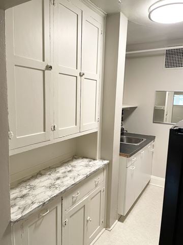 Saint Paul apartment for rent - A kitchen with white cabinets and a marble countertop.