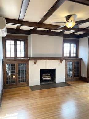 St. Paul apartment for rent - Elegant living room with coffered oak ceilings, brick fireplace, built-in oak buffet cabinets and hardwood floors.