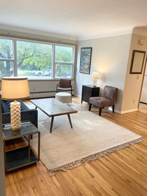 Saint Paul apartment for rent - A living room with a couch, chair, and lamp.