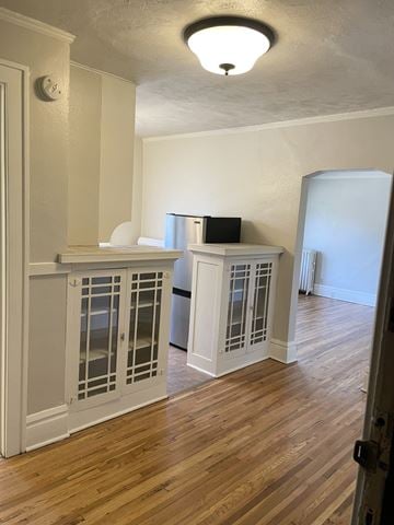 Saint Paul apartment for rent - A kitchen with white cabinets and a wooden floor.