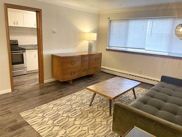 Saint Paul apartment for rent - A living room with a grey couch and a wooden coffee table.