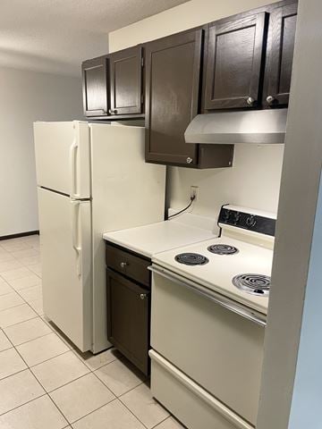 Fridley apartment for rent - A white refrigerator and a white stove with a black dishwasher in a kitchen.